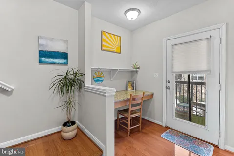 a view of a workspace with furniture and wooden floor