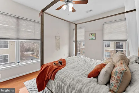 a bedroom with a bed and a large window