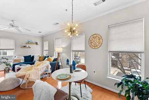 a living room with furniture a chandelier and a window