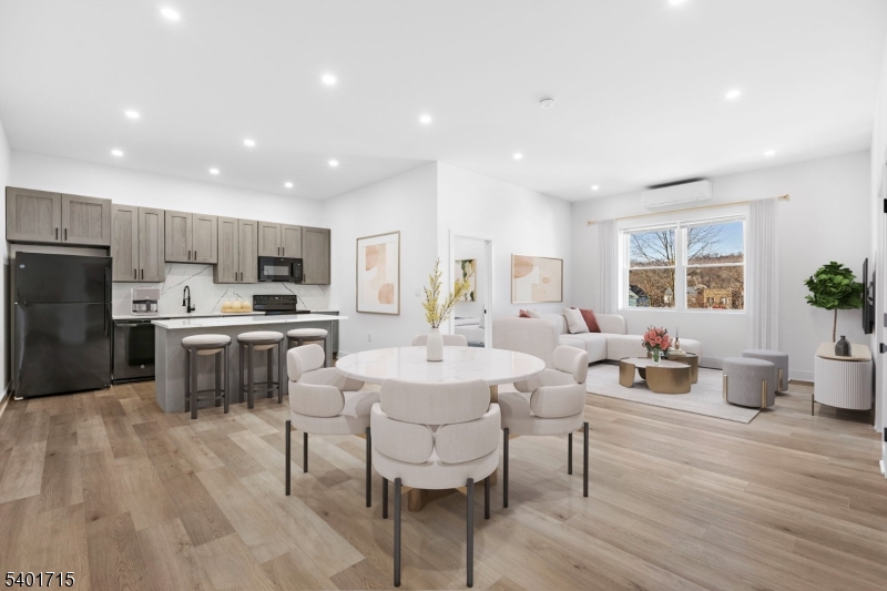 a large kitchen with kitchen island a white cabinets and stainless steel appliances