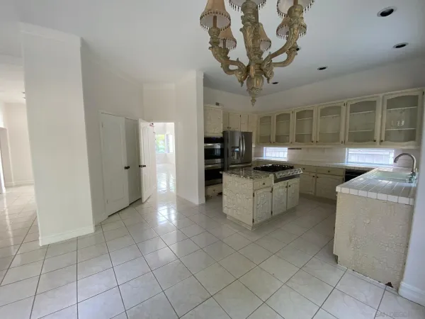 a kitchen with stainless steel appliances granite countertop a refrigerator and a stove