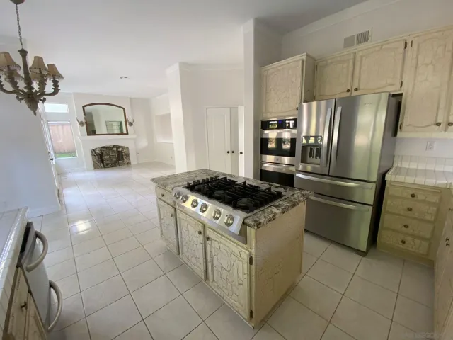 a kitchen with granite countertop a stove a sink a refrigerator and a granite counter tops