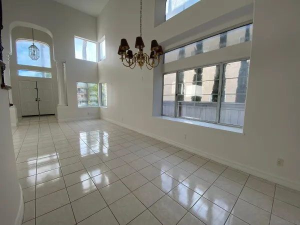 a view of an empty room with a fireplace and a window