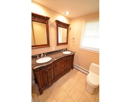 26 Mohawk Road Canton, MA 02021 - Photo 22 of 28 a bathroom with a sink a toilet and mirror