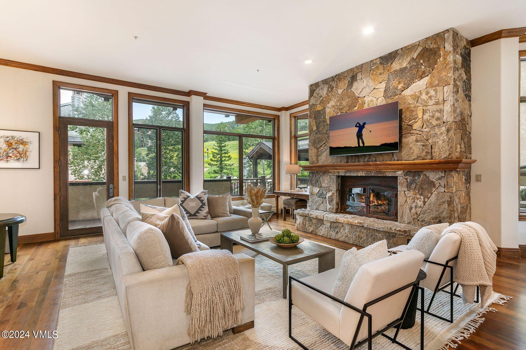 15 West Thomas Place, Unit R44 Beaver Creek, CO 81620 - Photo 1 of 21 a living room with furniture a large window and a fireplace