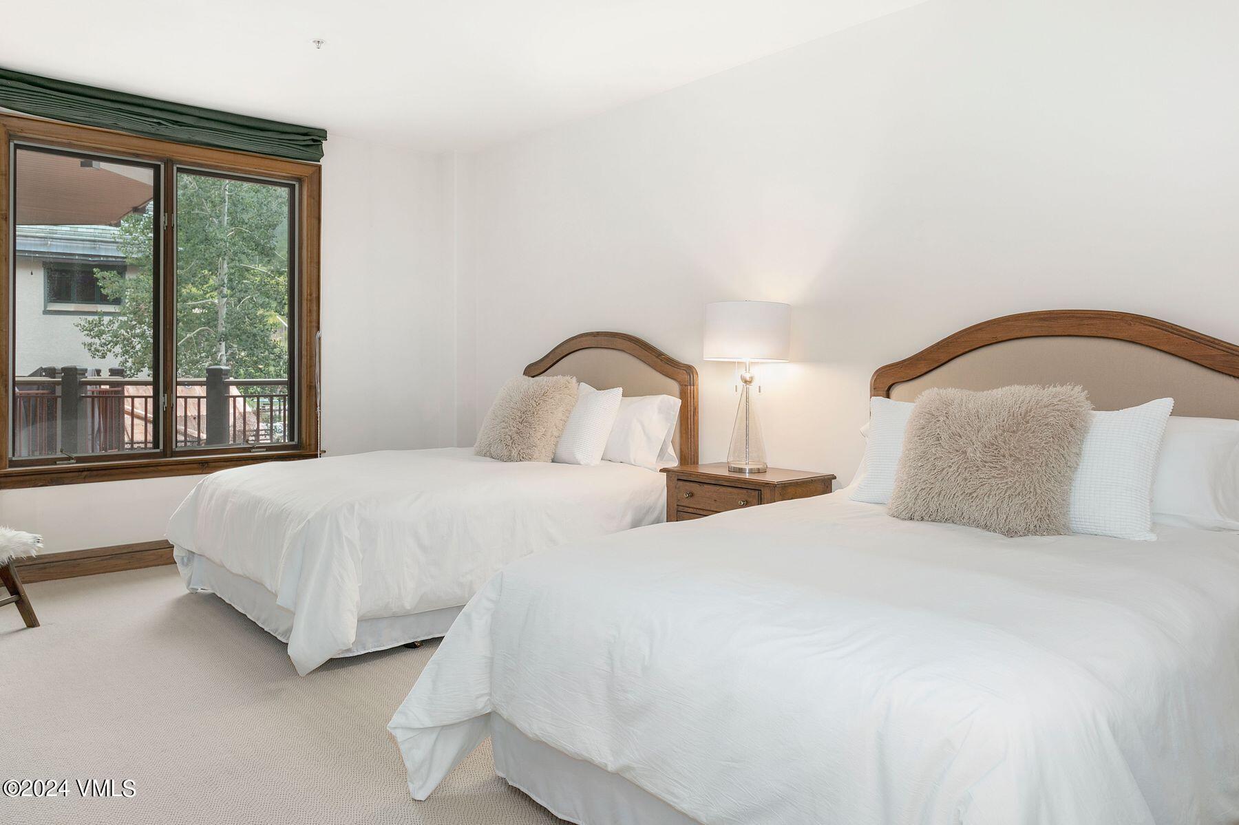 15 West Thomas Place, Unit R44 Beaver Creek, CO 81620 - Photo 16 of 21 a bedroom with a large bed and a large window