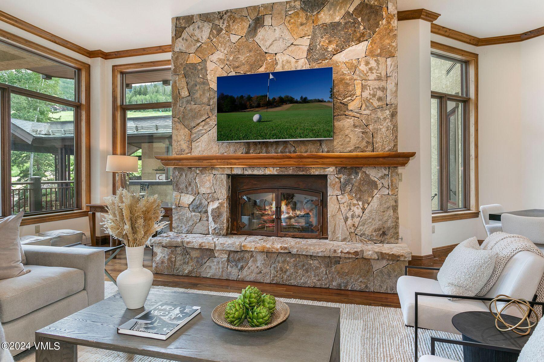 15 West Thomas Place, Unit R44 Beaver Creek, CO 81620 - Photo 2 of 21 a living room with furniture a flat screen tv and a fireplace