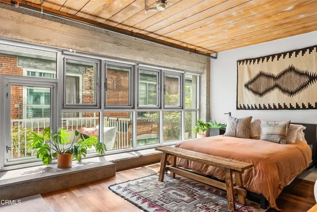 a bed sitting in a bedroom next to a window
