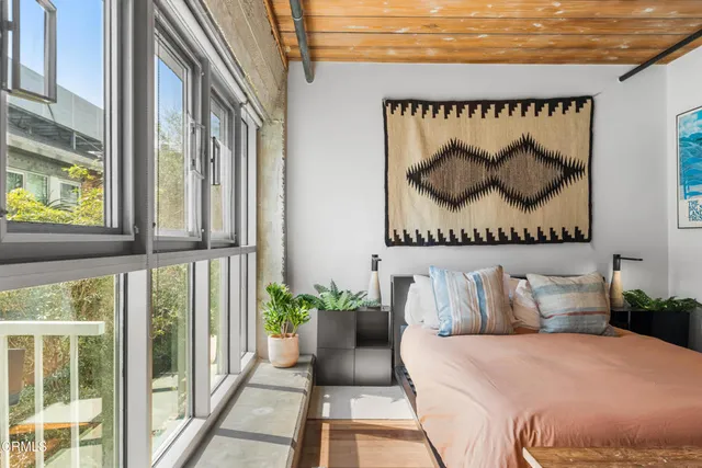 a bedroom with a bed and window