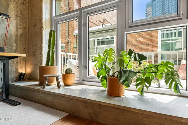 a vase of flowers sitting next to a window
