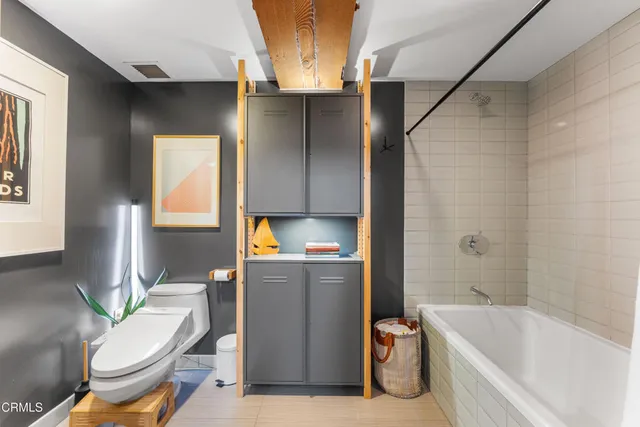 a bathroom with a toilet and a bathtub