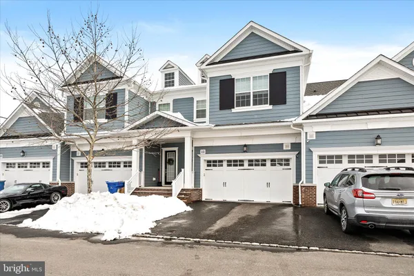 a view of a white house with a large space