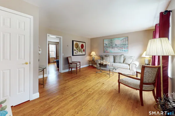 a living room with furniture and a wooden floor