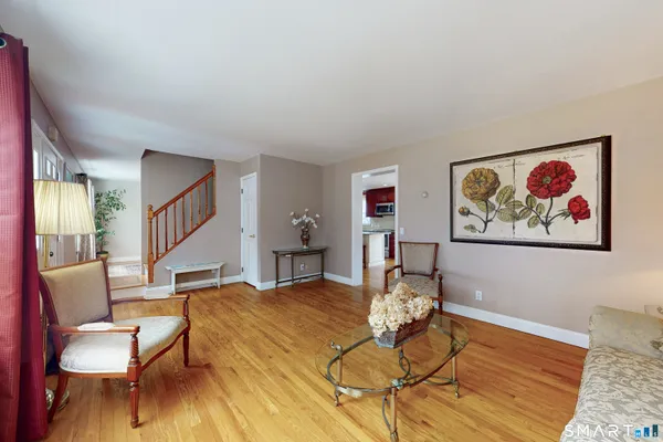 a living room with furniture and wooden floor