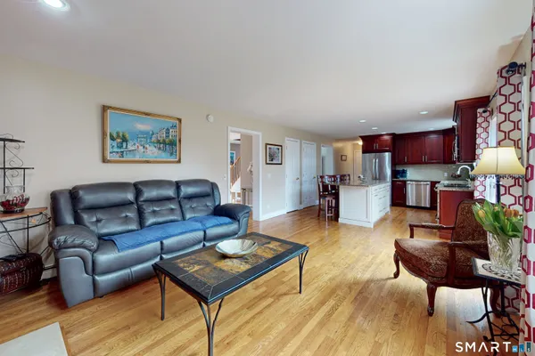 a living room with furniture and a wooden floor