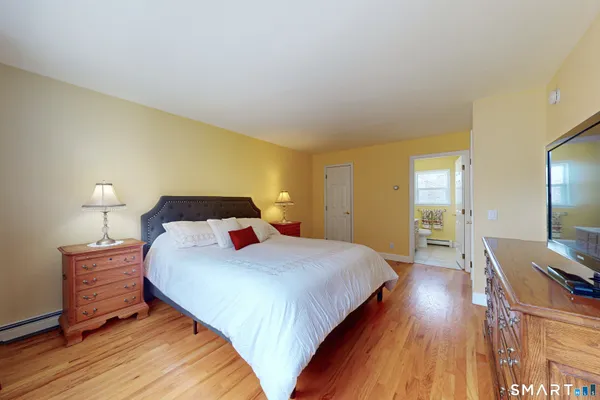 a bedroom with a bed and a flat screen tv