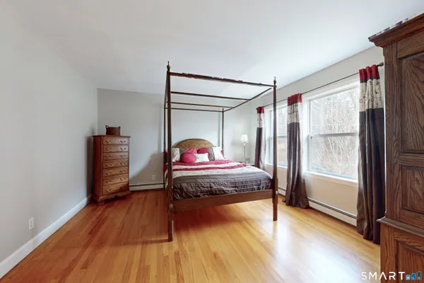 a bedroom with a large bed and a large window