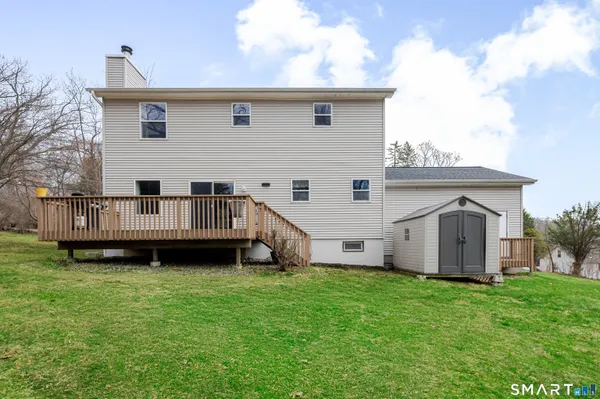 a view of a house with a yard and deck