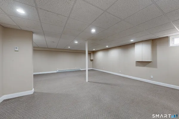 an empty room with window and pillar in it