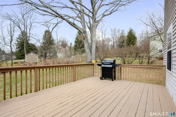 a view of a balcony with wooden floor and fence
