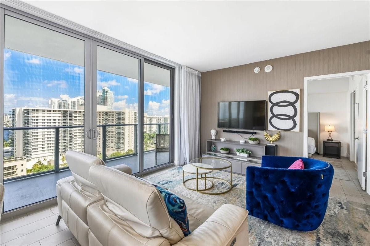 4010 South Ocean Drive, Unit R1102 Hollywood, FL 33019 - Photo 13 of 47 a living room with furniture and a large window