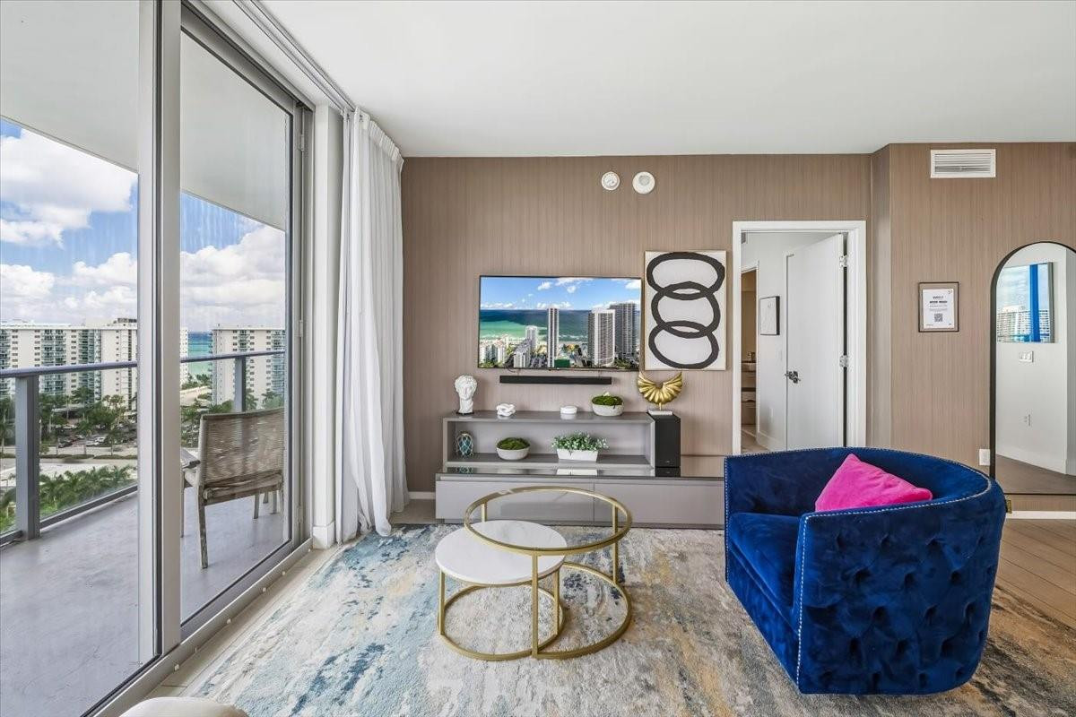 4010 South Ocean Drive, Unit R1102 Hollywood, FL 33019 - Photo 14 of 47 a living room with furniture a rug and white walls