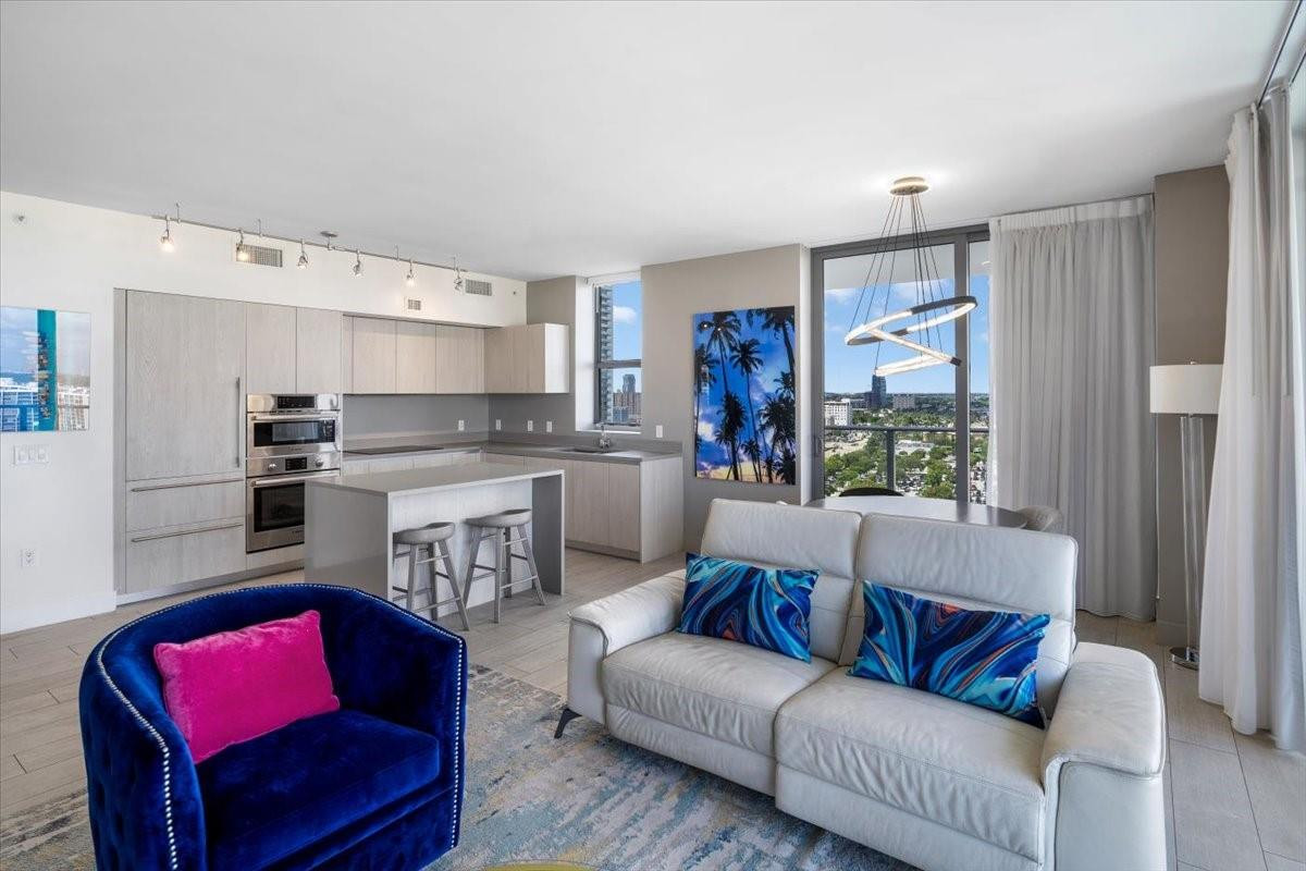 4010 South Ocean Drive, Unit R1102 Hollywood, FL 33019 - Photo 15 of 47 a living room with furniture and a large window