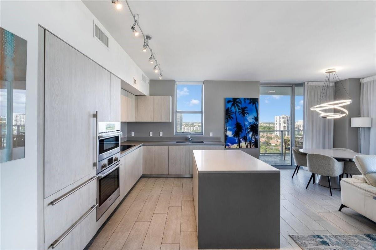 4010 South Ocean Drive, Unit R1102 Hollywood, FL 33019 - Photo 20 of 47 a large kitchen with cabinets a sink and a stove