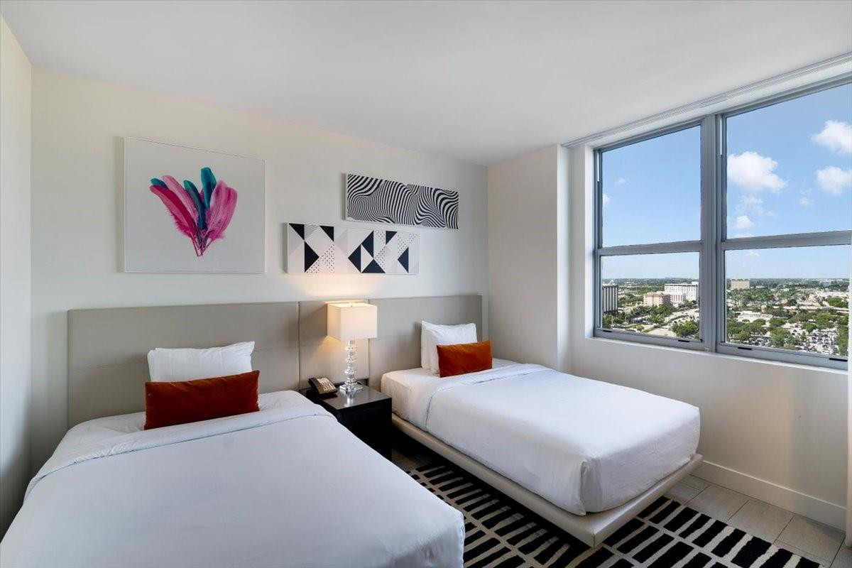 4010 South Ocean Drive, Unit R1102 Hollywood, FL 33019 - Photo 31 of 47 a bedroom with a bed and window