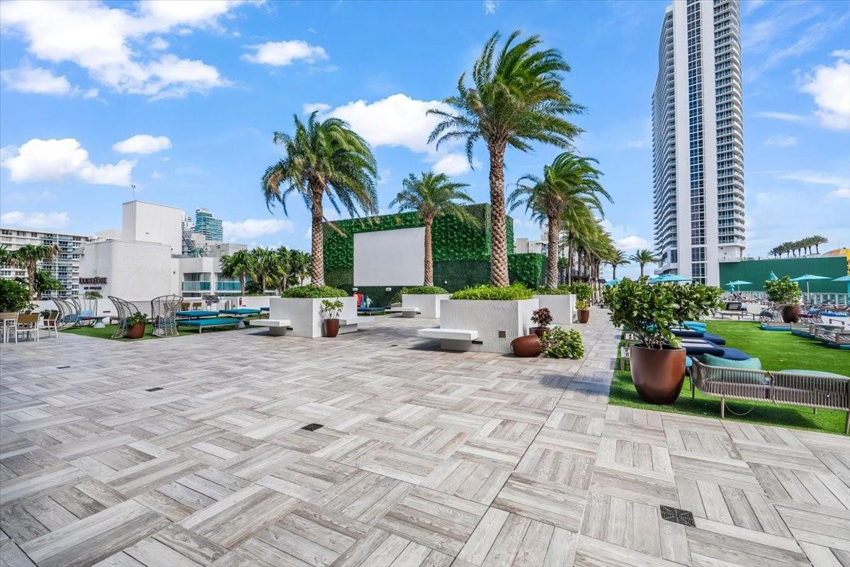 4010 South Ocean Drive, Unit R1102 Hollywood, FL 33019 - Photo 40 of 47 a row of palm trees in front of a house