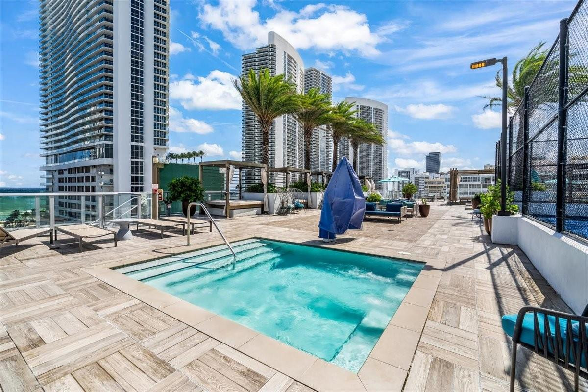4010 South Ocean Drive, Unit R1102 Hollywood, FL 33019 - Photo 45 of 47 a view of a patio with a table and chairs