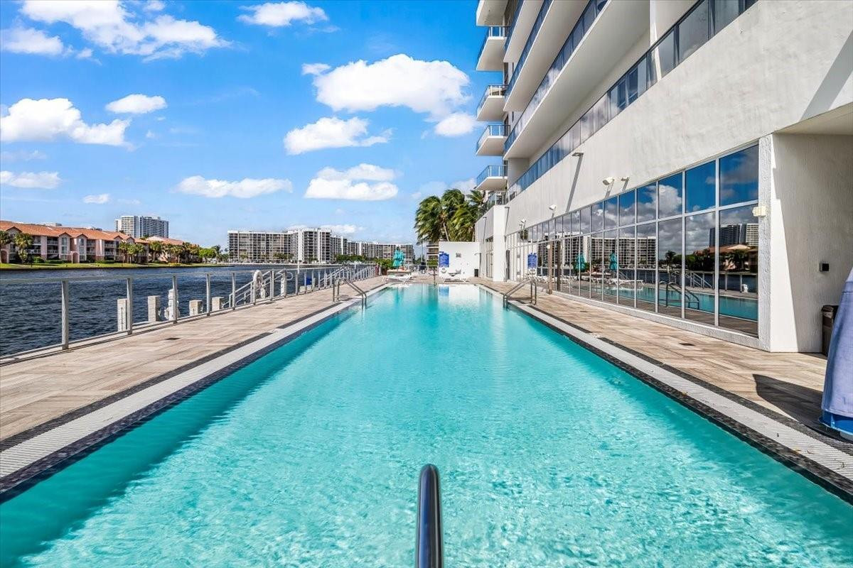 4010 South Ocean Drive, Unit R1102 Hollywood, FL 33019 - Photo 46 of 47 a view of a house with a patio and a yard