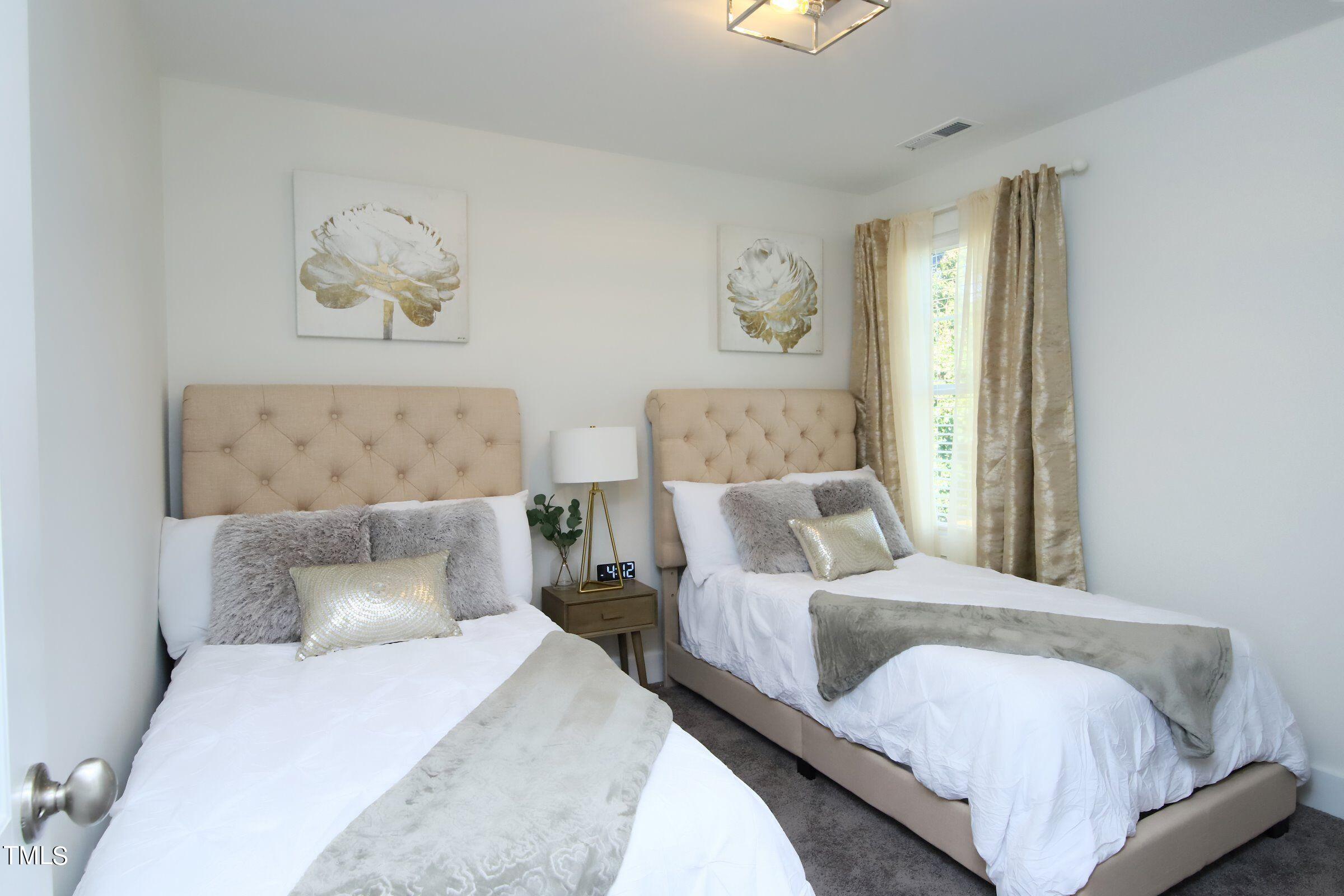 417 Como Drive Raleigh, NC 27610 - Photo 11 of 19 a bedroom with a bed and painting on the wall