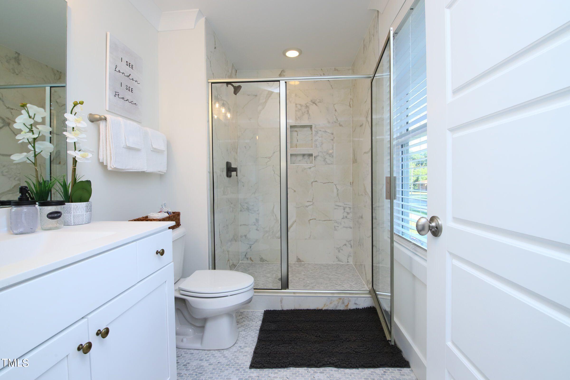 417 Como Drive Raleigh, NC 27610 - Photo 18 of 19 a bathroom with a sink a toilet a shower and a mirror