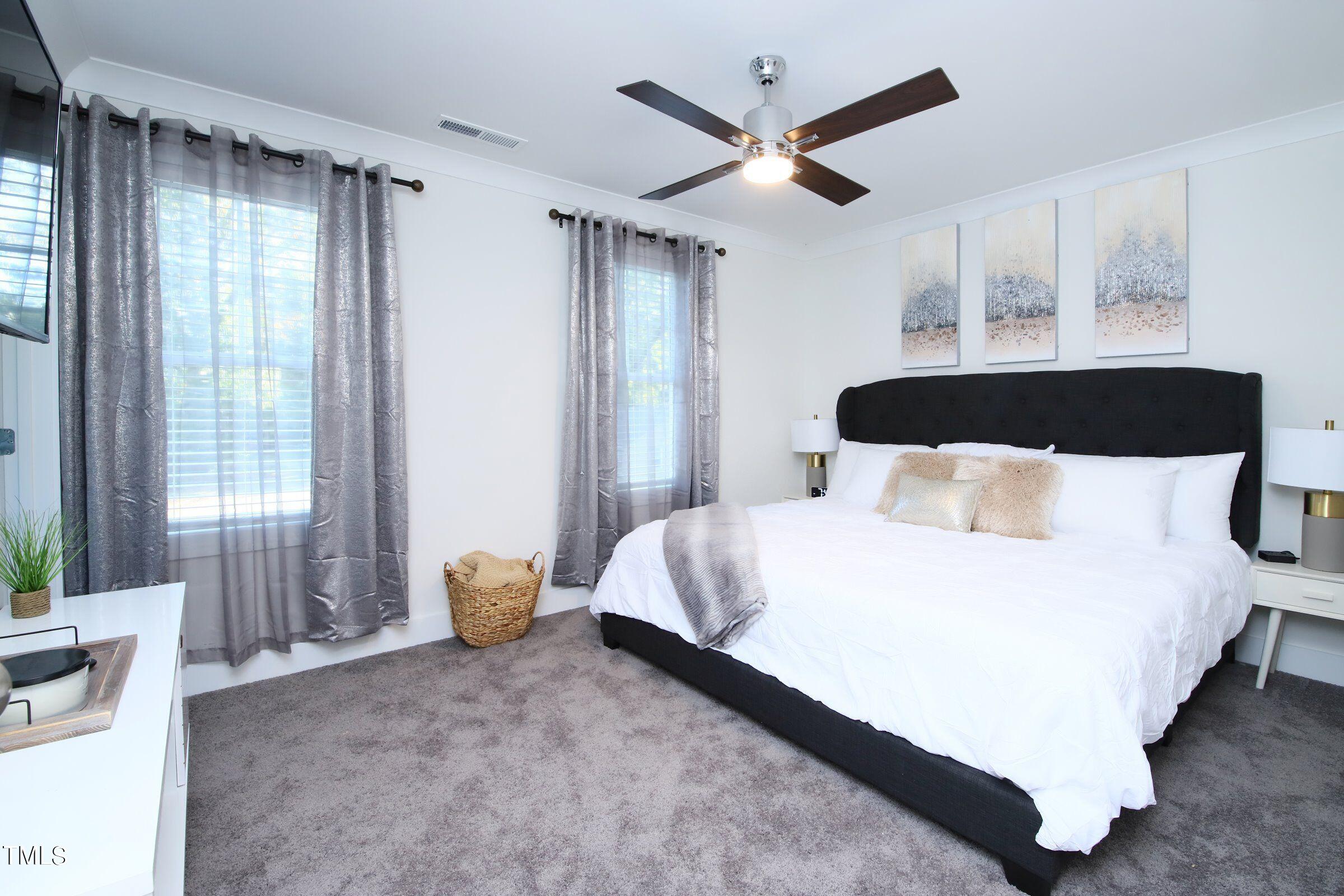 417 Como Drive Raleigh, NC 27610 - Photo 19 of 19 a bedroom with a bed and a large window