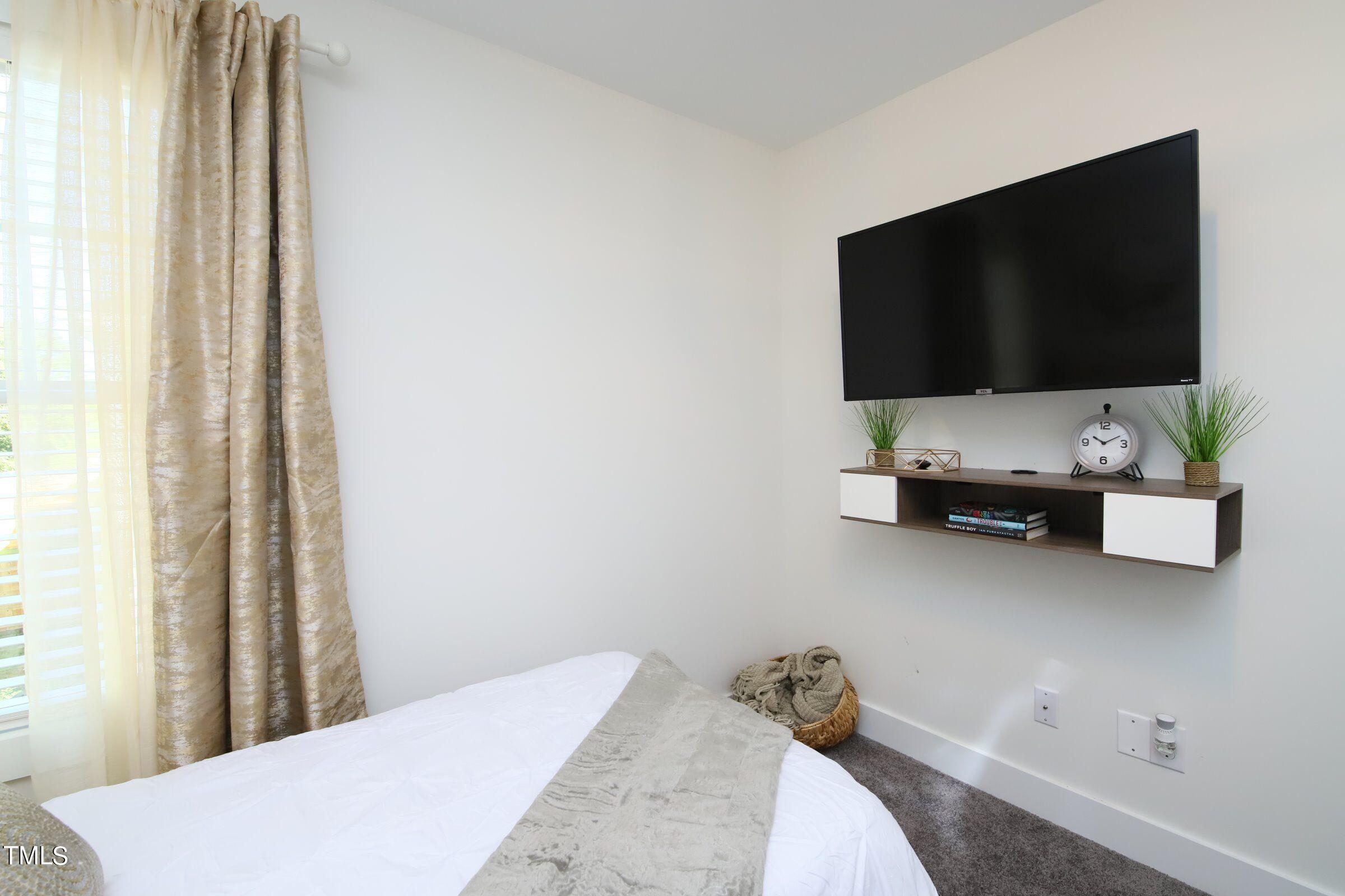 417 Como Drive Raleigh, NC 27610 - Photo 8 of 19 a living room with a flat screen tv and a window