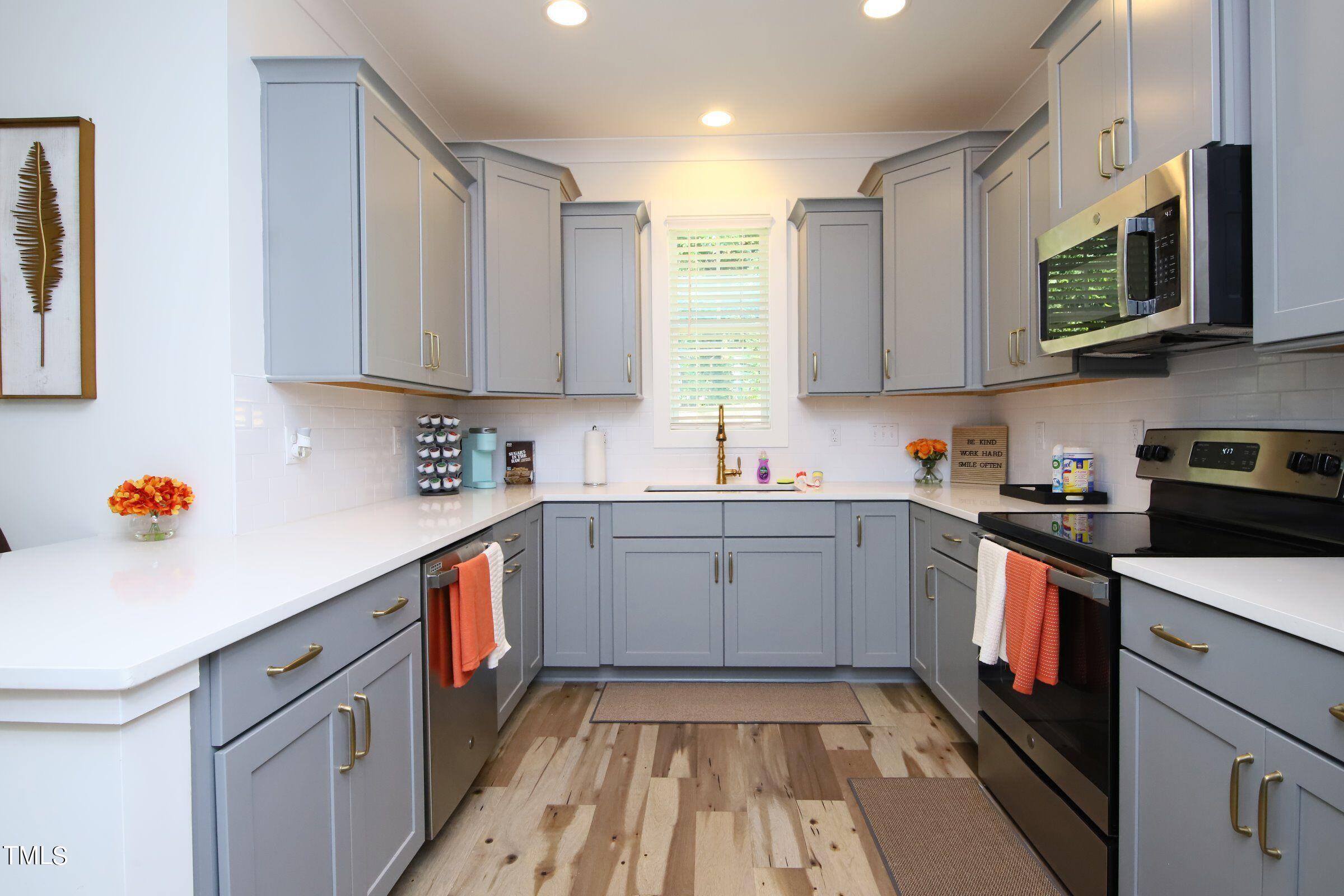 417 Como Drive Raleigh, NC 27610 - Photo 10 of 19 a kitchen with a sink cabinets and stainless steel appliances