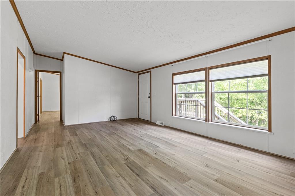 580 Gameland Road Polk, PA 16342 - Photo 7 of 25 a view of an empty room with wooden floor and a window