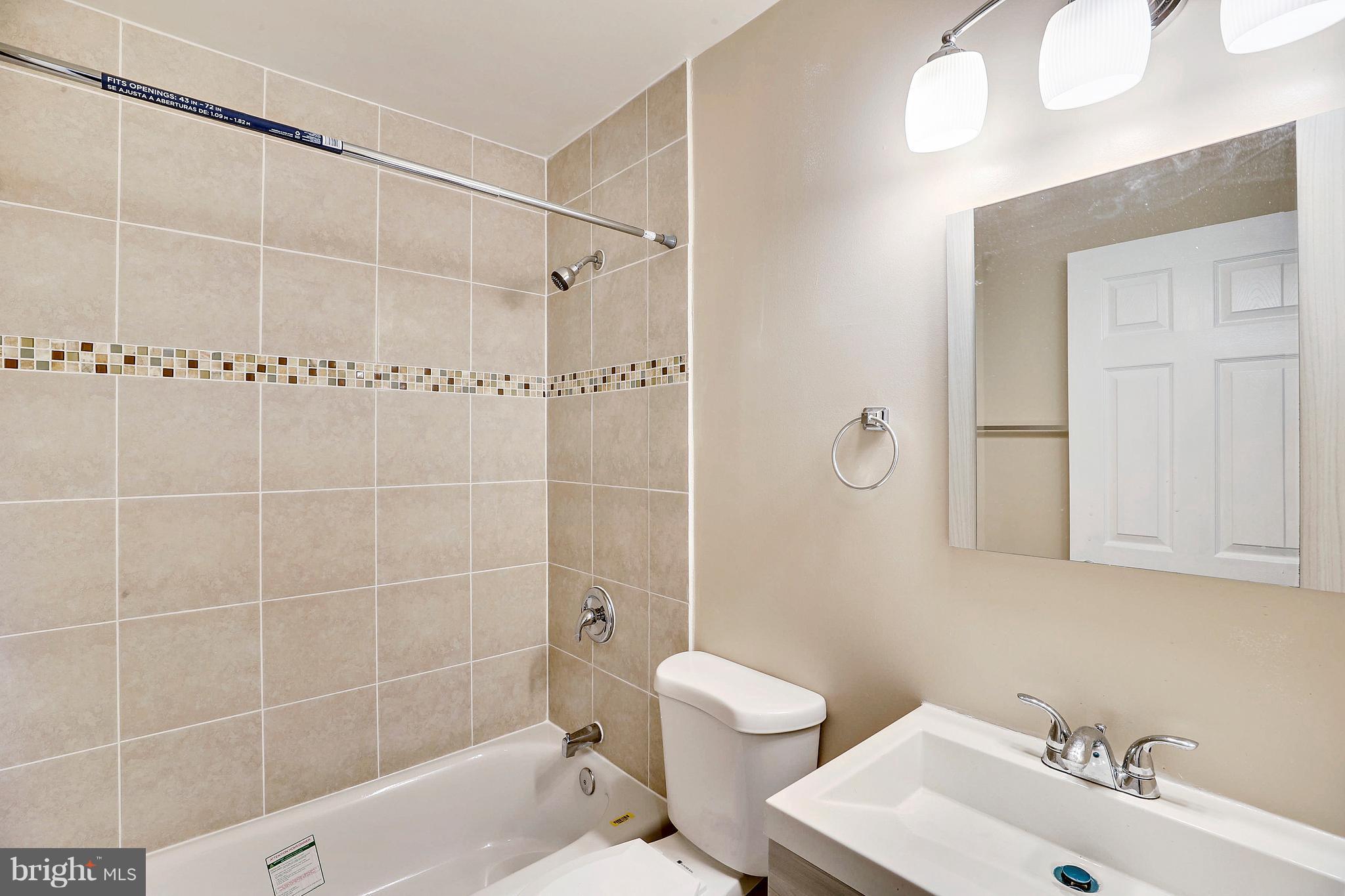 1718 Newcastle Road Baltimore, MD 21244 - Photo 7 of 9 a bathroom with a sink toilet and shower