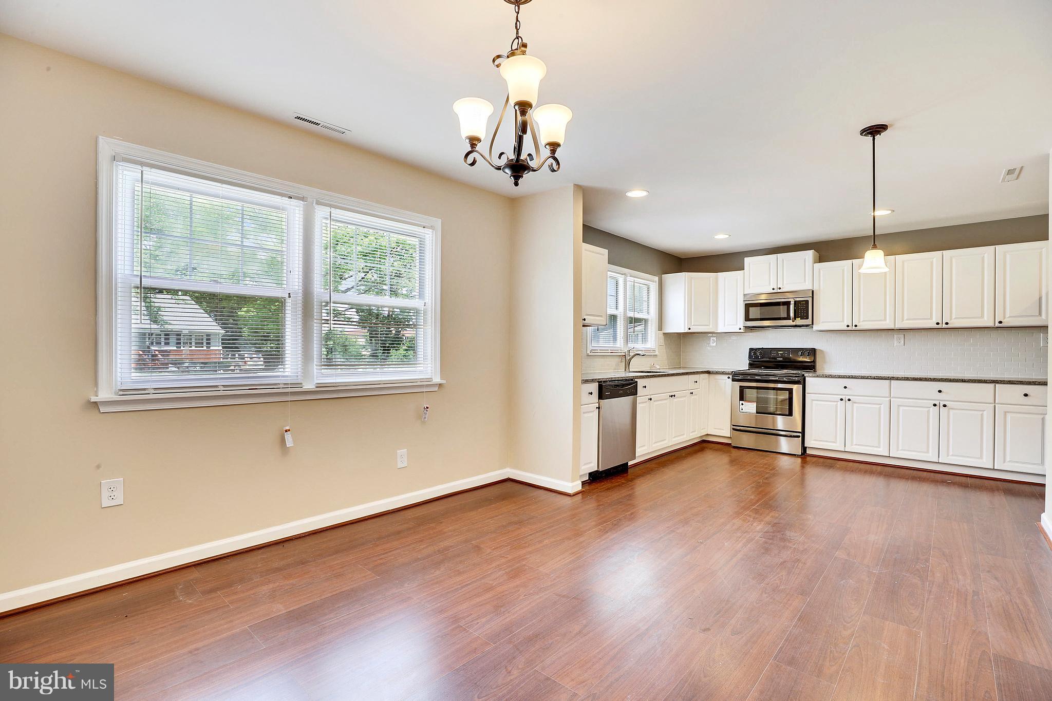 1718 Newcastle Road Baltimore, MD 21244 - Photo 9 of 9 a view of kitchen with microwave and wooden floor