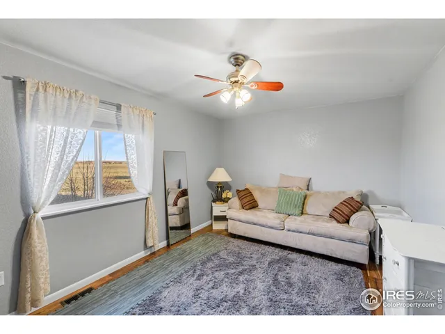 a bedroom with two beds and painting on the wall