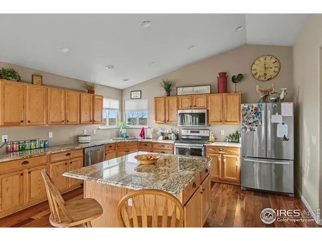 a living room with furniture a dining table and a chandelier