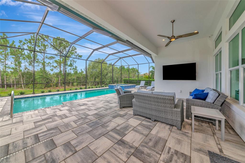 16620 Collingtree Crossing Lakewood Ranch, FL 34202 - Photo 14 of 48 a view of a patio with a table chairs and a yard