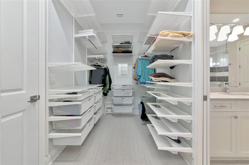 16620 Collingtree Crossing Lakewood Ranch, FL 34202 - Photo 23 of 48 a view of walk in closet with clothes and shoes