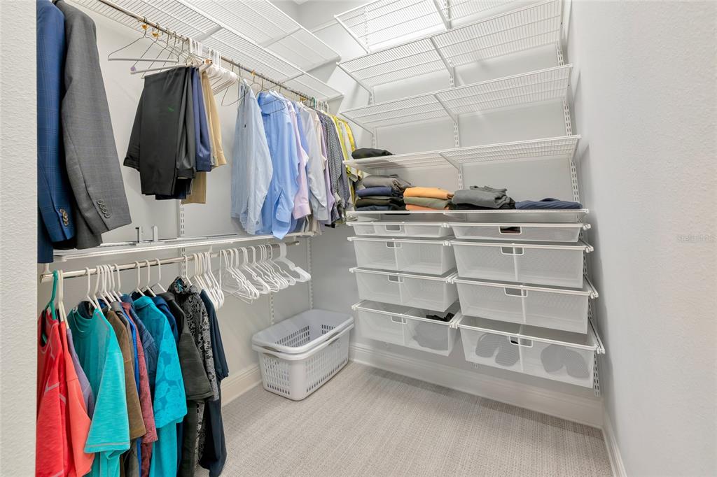 16620 Collingtree Crossing Lakewood Ranch, FL 34202 - Photo 24 of 48 a view of walk in closet with clothes and shoes