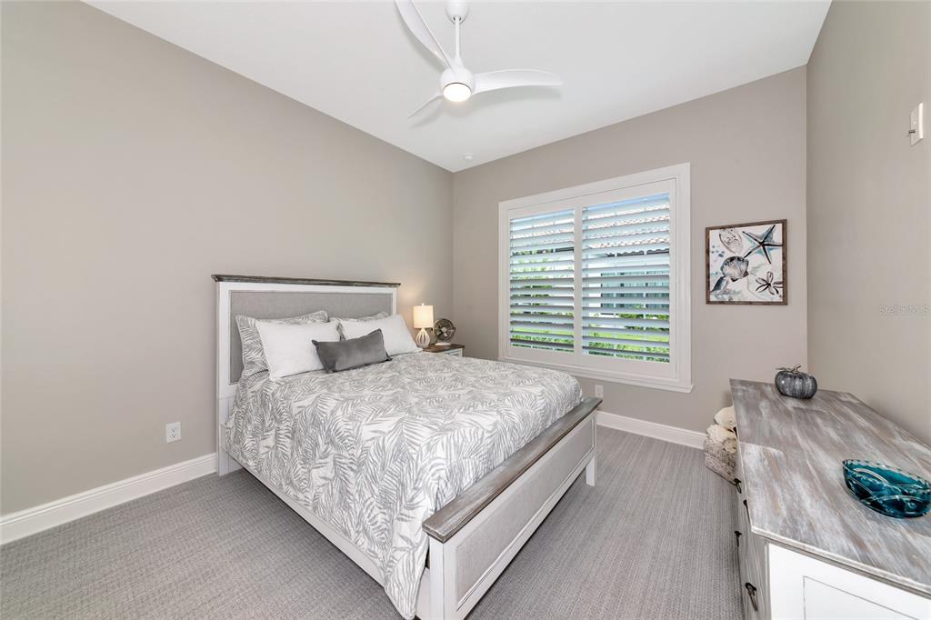 16620 Collingtree Crossing Lakewood Ranch, FL 34202 - Photo 29 of 48 a bed sitting in a bedroom next to a window