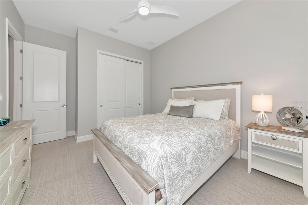 16620 Collingtree Crossing Lakewood Ranch, FL 34202 - Photo 30 of 48 a bedroom with a bed and a chandelier