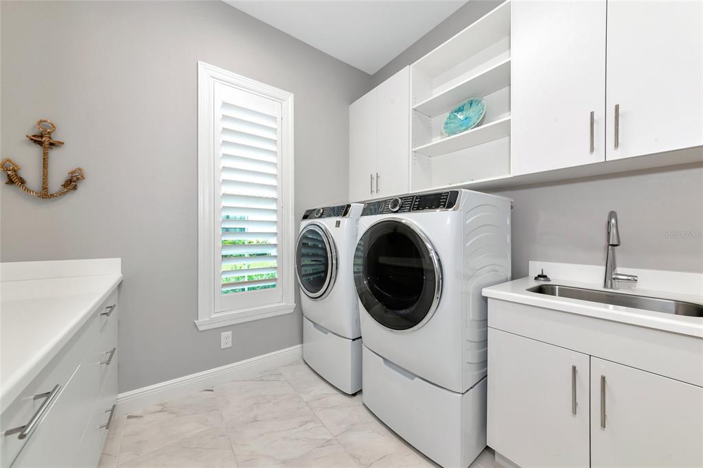 16620 Collingtree Crossing Lakewood Ranch, FL 34202 - Photo 33 of 48 a utility room with sink dryer and washer