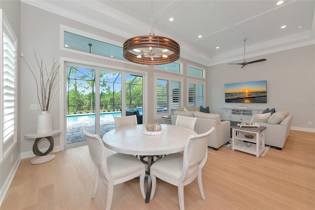 16620 Collingtree Crossing Lakewood Ranch, FL 34202 - Photo 10 of 48 a view of a dining room with furniture wooden floor and chandelier