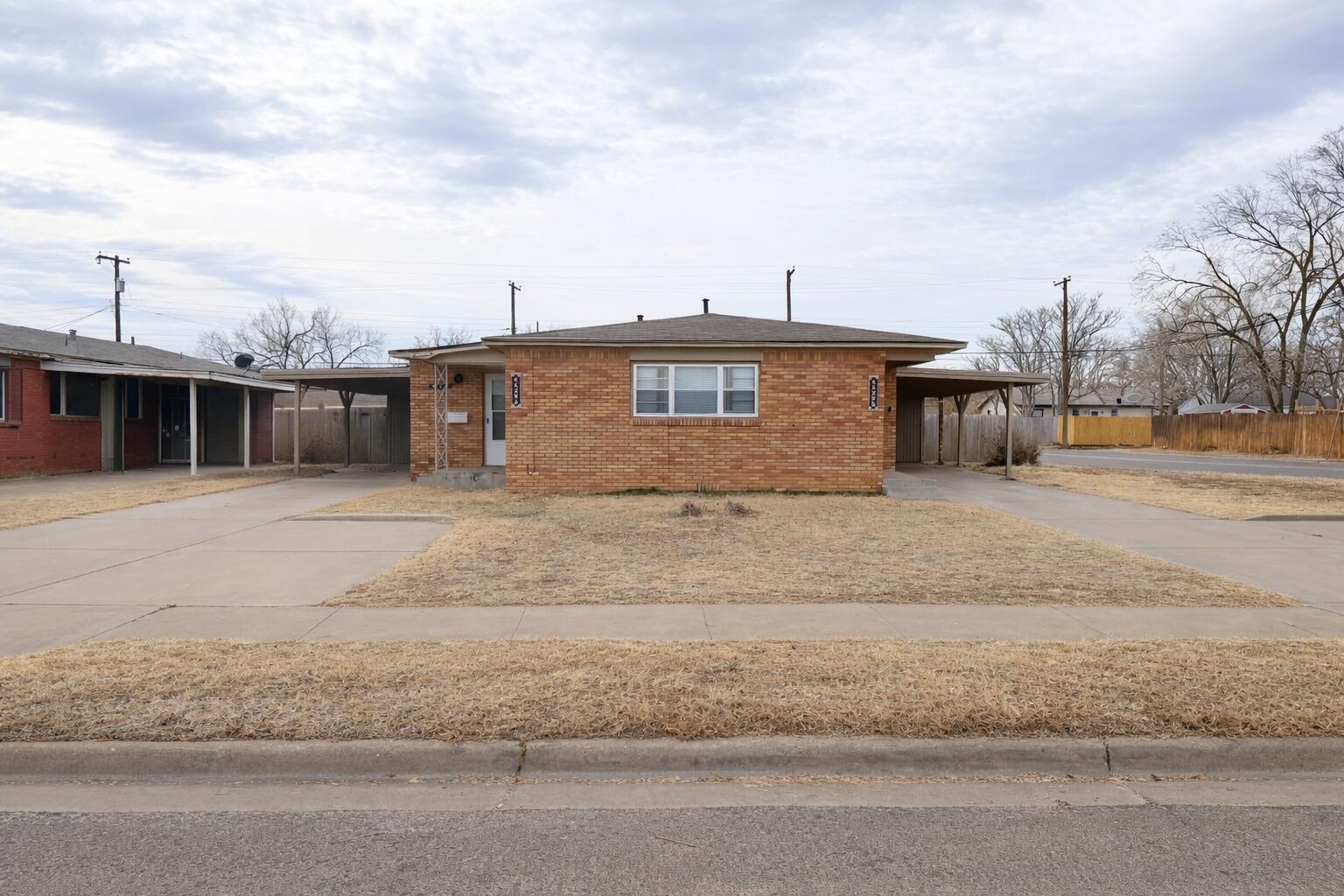 4429 31st Street Lubbock, TX 79410 - Photo 1 of 12 a front view of a house with a yard
